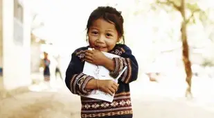 Little Girl Clutching Book