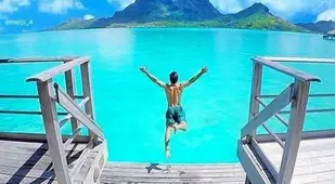 Man Jumping Into Tropical Ocean