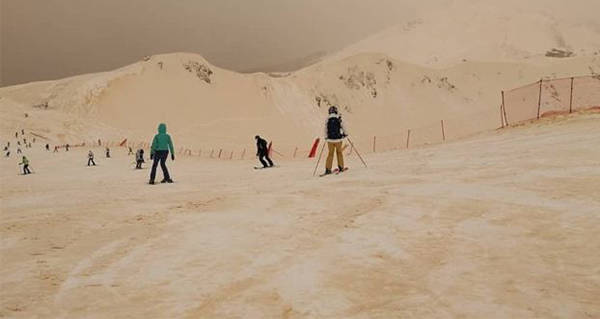 Skiers Orange Snow