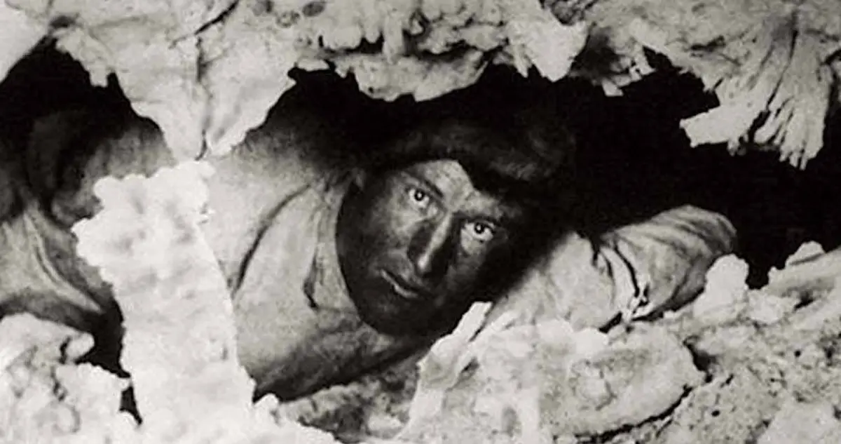 A black-and-white photograph of Floyd Collins inside Crystal Cave, which he discovered on his own family's property