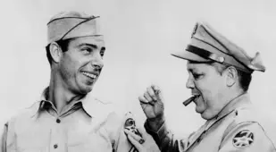 Joe Dimaggio getting a new patch on his WWII uniform