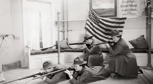 Women In Uniform Shoot Before Flag