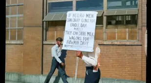 Black Man Protesting Outside A Milk Factory