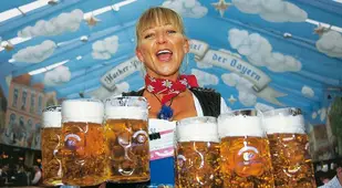 Waitress Carries Beer Steins