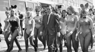 Hefner Walking With Women