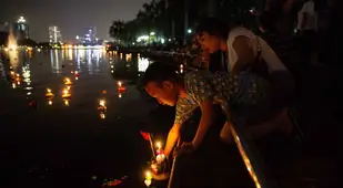 Boy Puts Down Loy Krathong Offering
