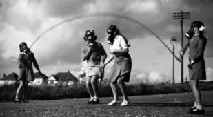 Girls Wearing Gas Masks Playing