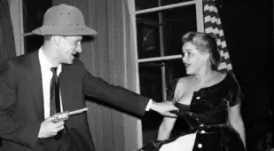 Hefner Holding Gun