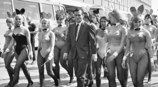 Hefner Walking With Women