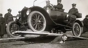 Man Supports Automobile On His Back