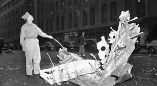 A man stands over debris from the Empire State Building plane crash