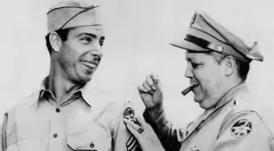 Joe Dimaggio getting a new patch on his WWII uniform