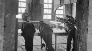 Men Deliberate In Hiroshima Ruins
