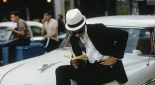 Man Reads On A Plymouth