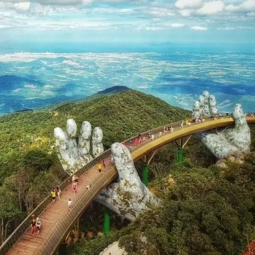 Explore Cau Vang, The Vietnam Bridge That Appears As If It's Made Of Solid Gold And Held Up By Giant Hands