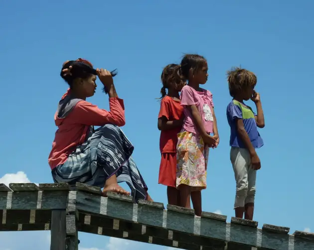 Children Standing On A Dock