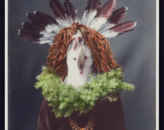 Native American Man Wearing Feathered Mask