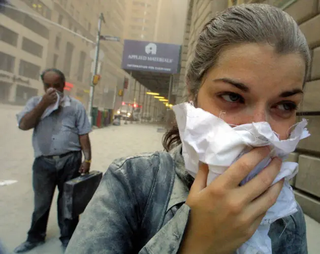 Ash Covered Woman Covers Her Face