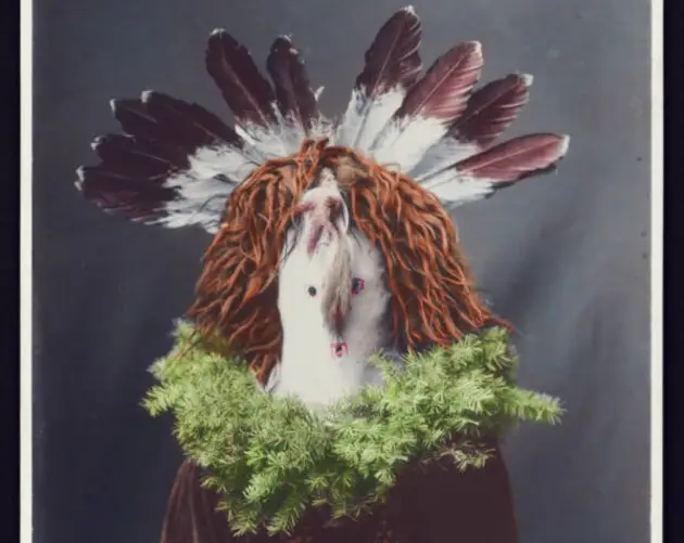Native American Man Wearing Feathered Mask