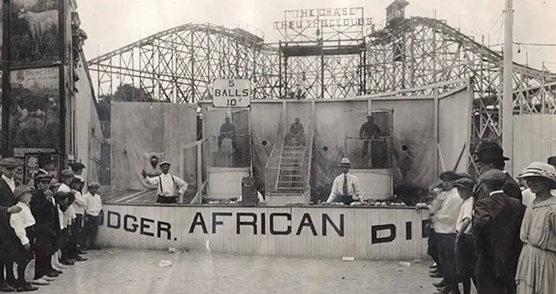 The History Of Racist Carnival Games Like ‘African Dodger’ — Which Evolved Into The Dunk Tanks Still Used Today