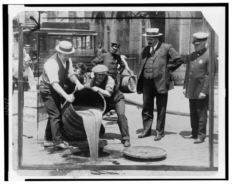 Prohibition Agents Dumping Booze Into The Sewer