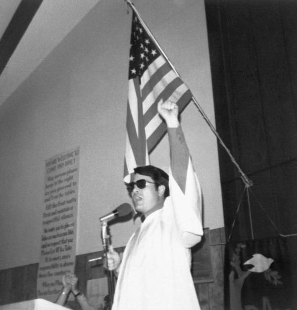 Jim Jones In Front Of Flag