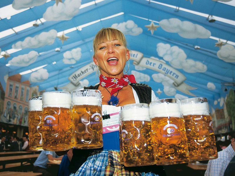 Waitress Carries Beer Steins