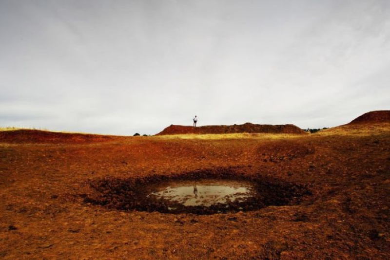 A farmer with a puddle that had once been a dam Source: ABC
