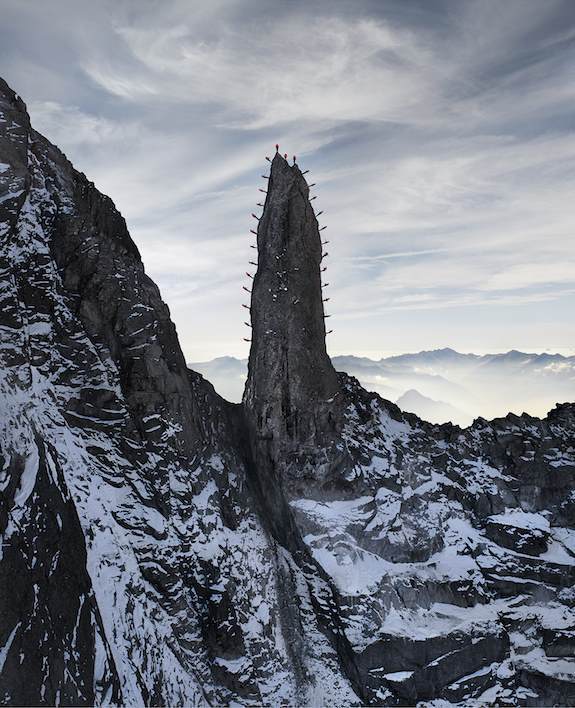 Climbers On Spire In Swiss Alps.