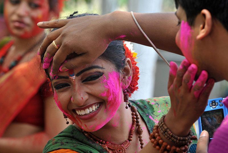 Woman Colors Face for Holi