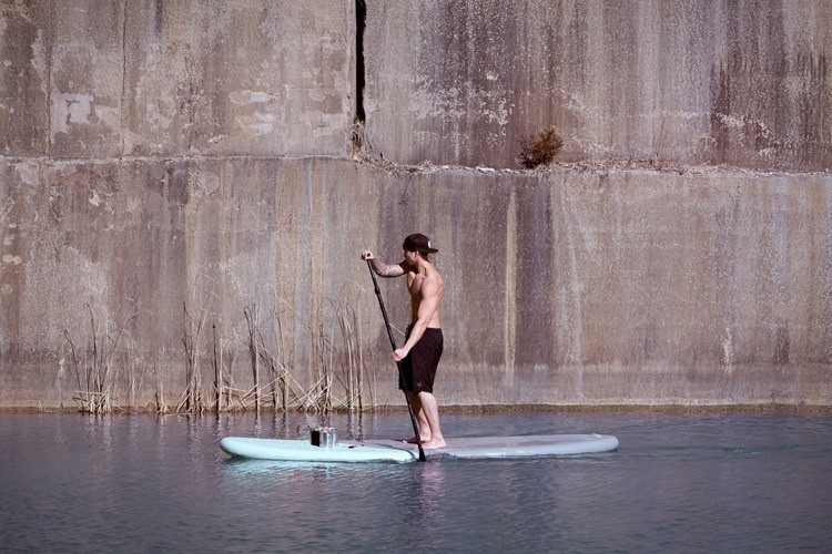 mysterious waterfront women paddleboat