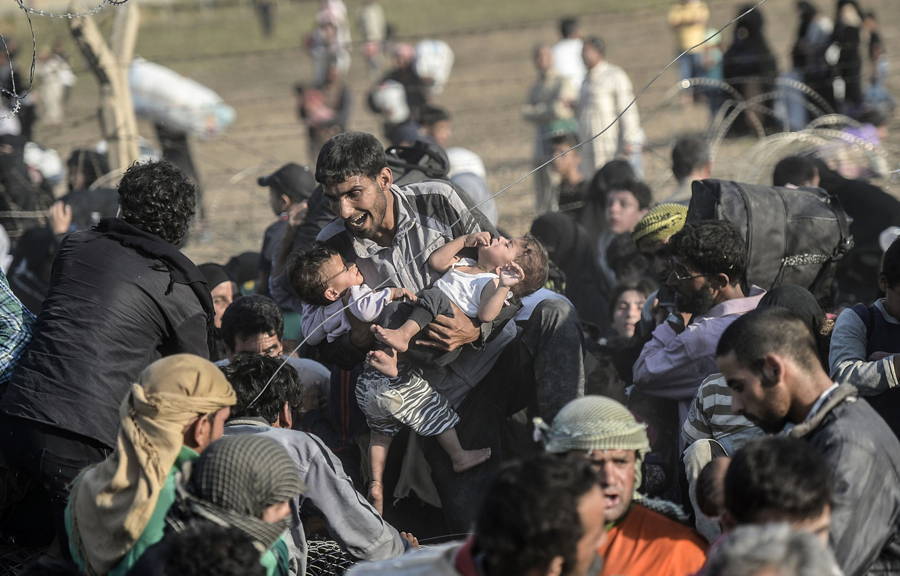 Syrian Refugee Holding Children