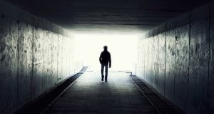 Man Walking Dark Corridor
