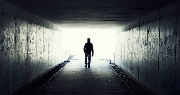 Man Walking Dark Corridor