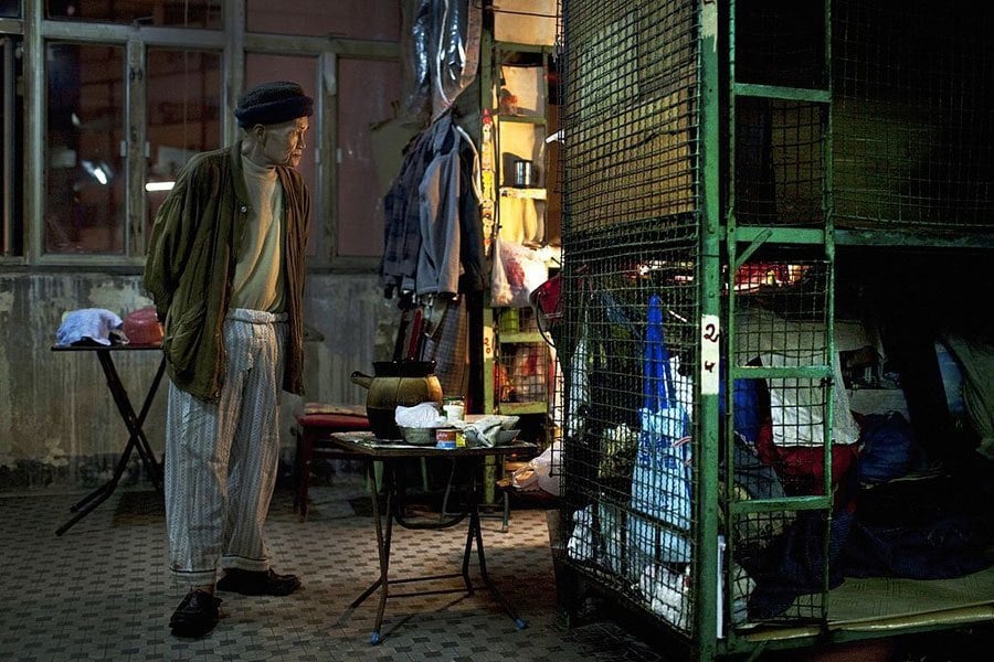 Man Beside Hong Kong Cage House