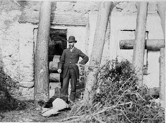 Man Standing Before House
