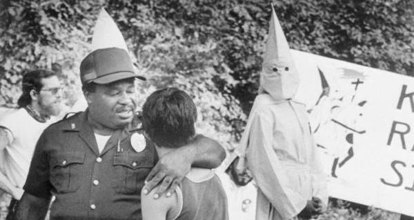 Image of Children in Ku Klux Klan costumes pose with Ku Klux