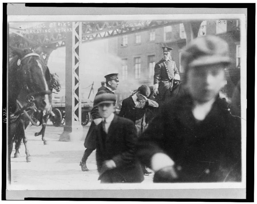 Policemen Arresting Striker