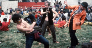 Hippies Dancing In Vests
