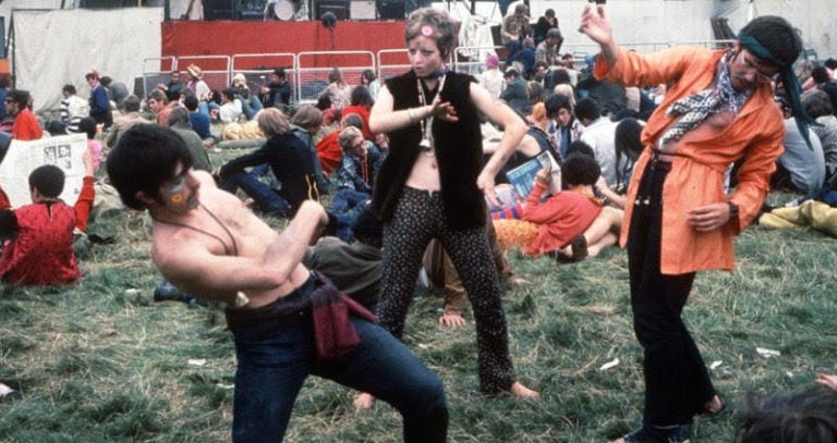 Hippies Dancing In Vests