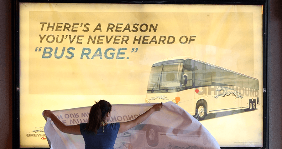 Woman covers up a bus rage advertisement