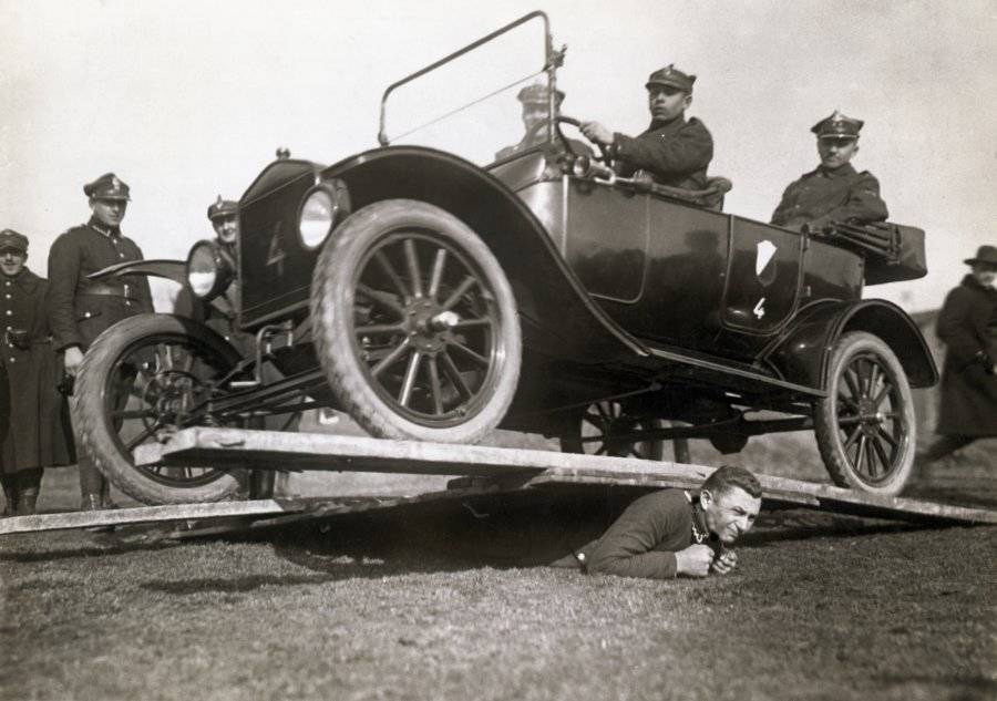 Man Supports Automobile On His Back