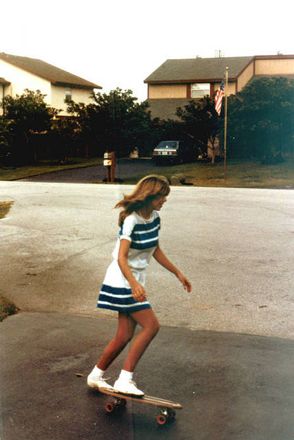 Woman Skateboarding In Dress
