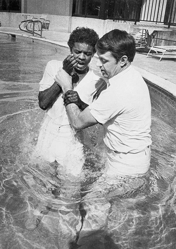 Mormon priest baptising Larry Lester