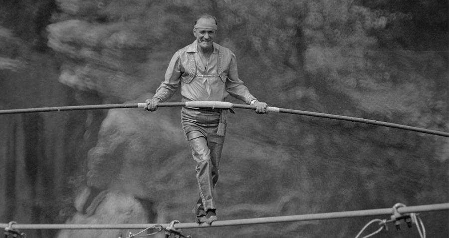 High wire artist Karl Wallenda tightrope walking across Fulton