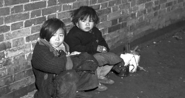 Two Children Against Wall