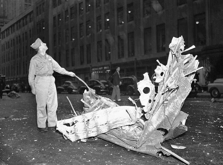 A man stands over debris from the Empire State Building plane crash