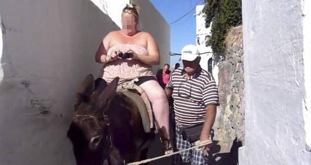 Tourist rides a Donkey