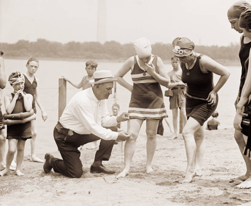 Man Measuring Flappers' Bathing Suits