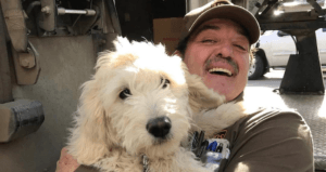 Man Smiling Holding White Dog